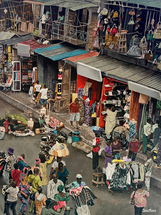 A bustling outdoor Nigerian market street scene with many people walking and shopping beside clothing stalls, hanging bags, and colorful shop fronts under corrugated metal roofs.